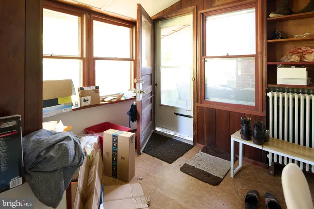 a dining room with furniture and a floor to ceiling window