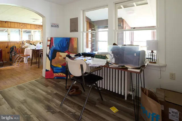 a living room with furniture a rug and a floor to ceiling window