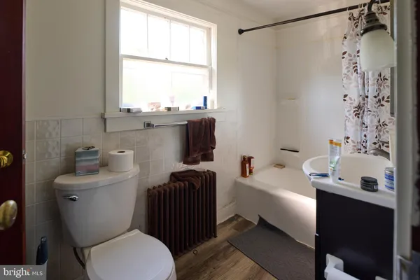 a bathroom with a sink toilet tub and shower