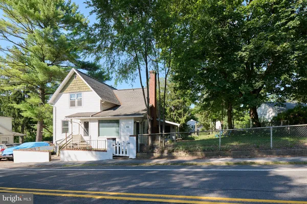 a front view of a house with a yard table and chairs