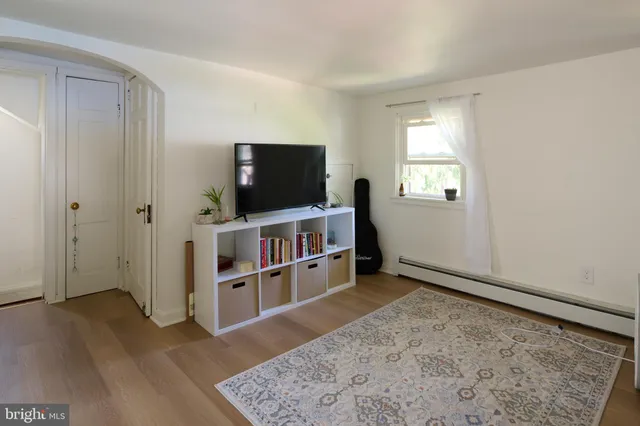 a living room with furniture windows and a flat screen tv