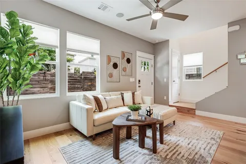 a living room with a large window and a fireplace