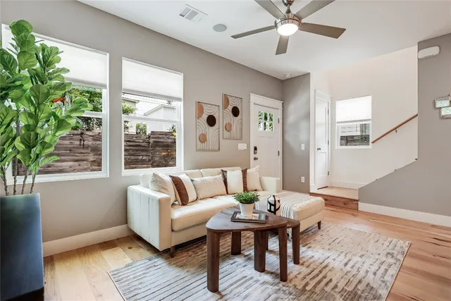 a living room with a large window and a fireplace