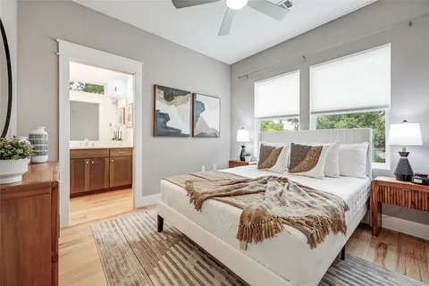 a bed sitting in a bedroom next to a window