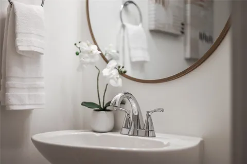 a bathroom with a sink a toilet and a mirror