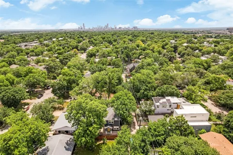 an aerial view of a house with a yard and garden