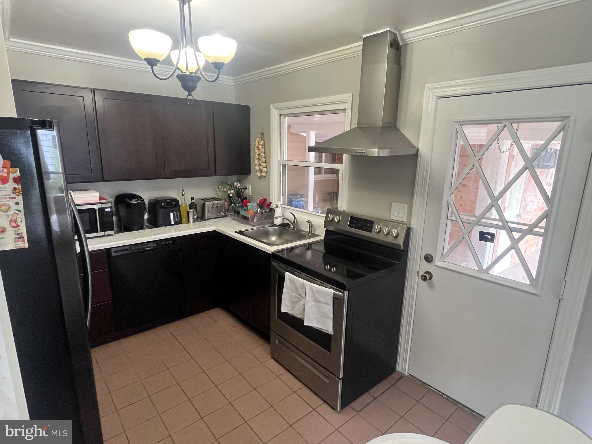 4111 Lawrence Street Alexandria, VA 22309 - Photo 2 of 42 a kitchen with stainless steel appliances a sink stove and refrigerator