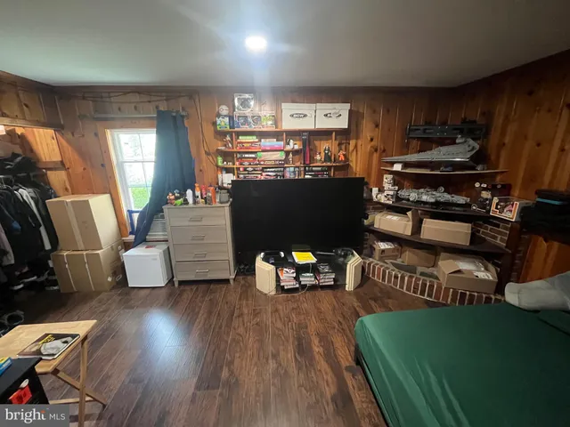 a bedroom with a bed and a tv