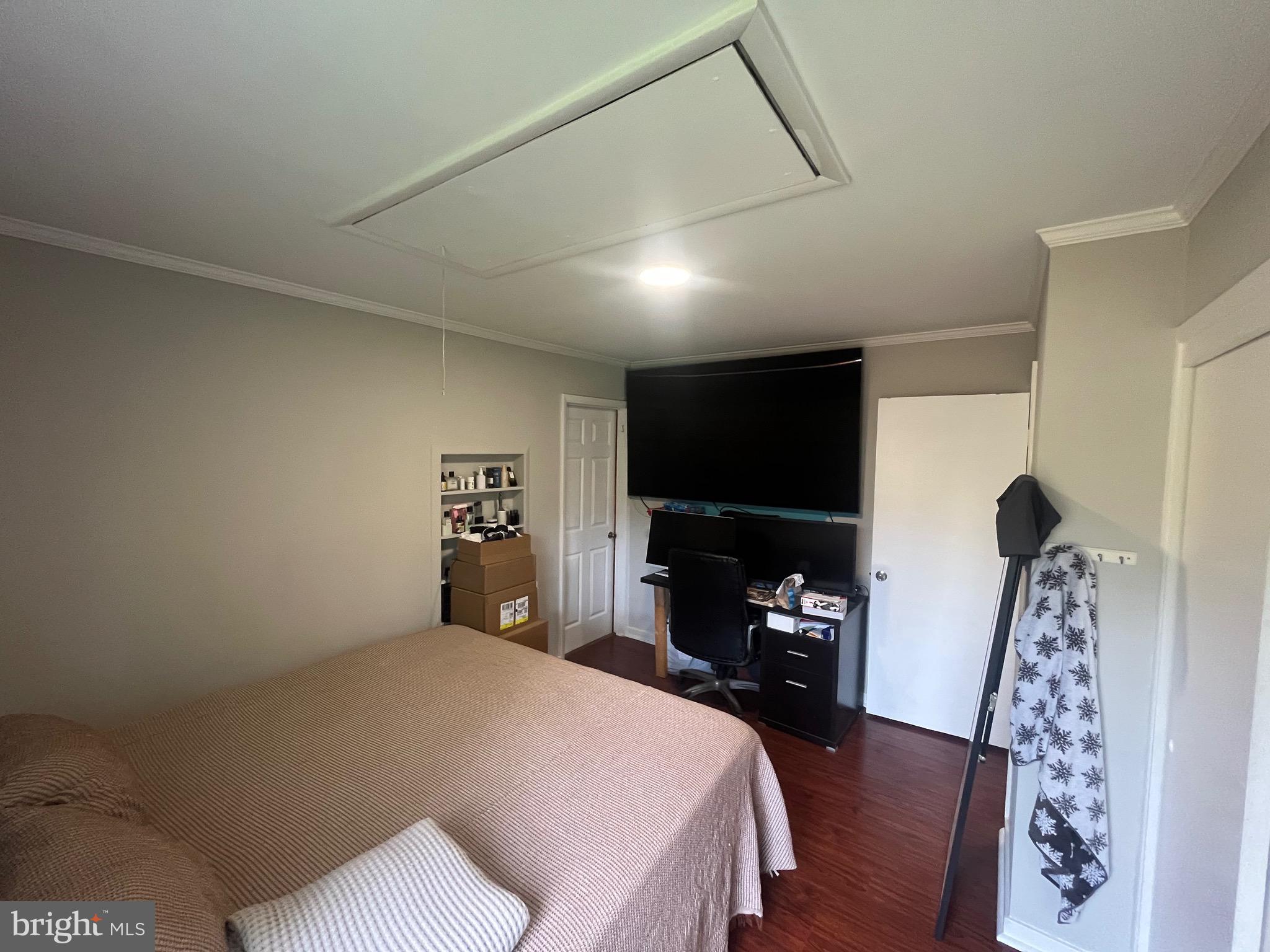 4111 Lawrence Street Alexandria, VA 22309 - Photo 30 of 42 a bedroom with a bed and a flat tv screen on the dresser