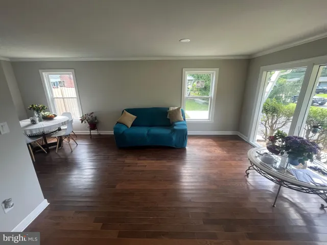 a living room with furniture window and wooden floor