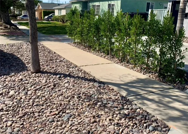 a view of a pathway both side of the house