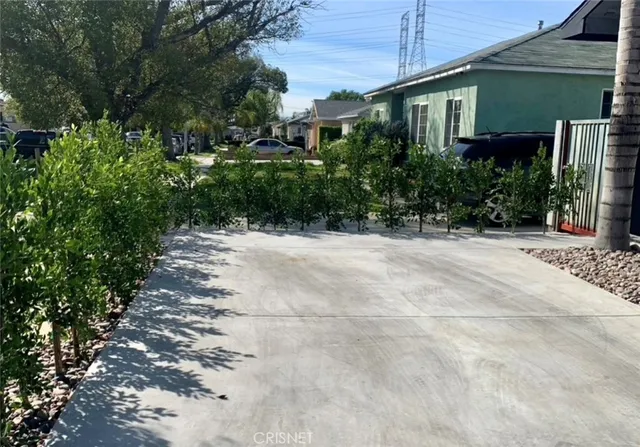 a view of a house with potted plants