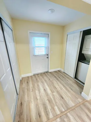 a view of empty room with wooden floor