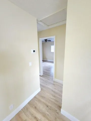 a view of a hallway with wooden floor