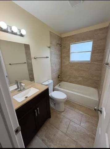 a bathroom with a sink a toilet and bathtub