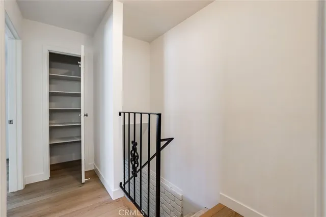 a view of a hallway with wooden floor and entryway