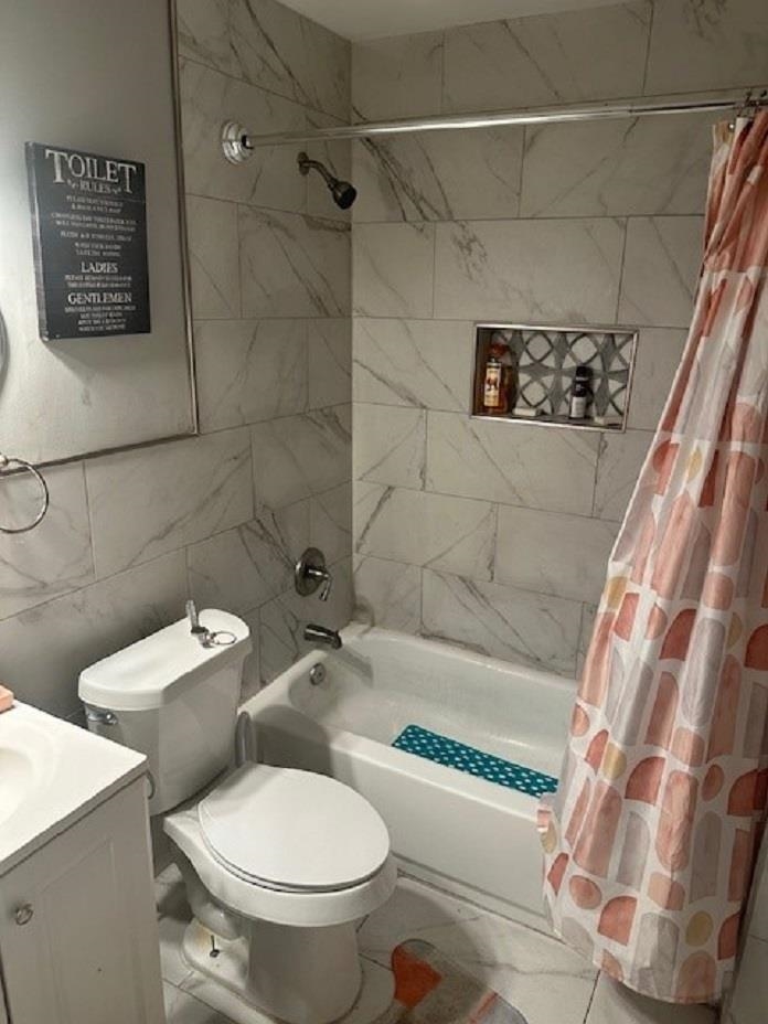 2618 Walnut Road Memphis, TN 38128 - Photo 5 of 6 a white toilet sitting next to a bath tub and a shower
