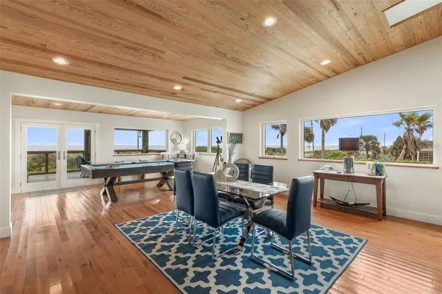 a living room with patio furniture and a potted plants