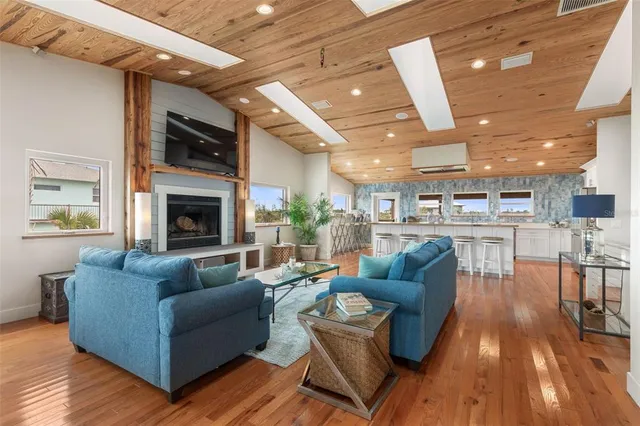 a kitchen with stainless steel appliances kitchen island granite countertop a refrigerator and wooden cabinets