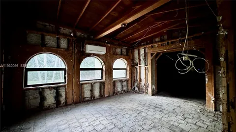 a living room with furniture a fireplace and a large window