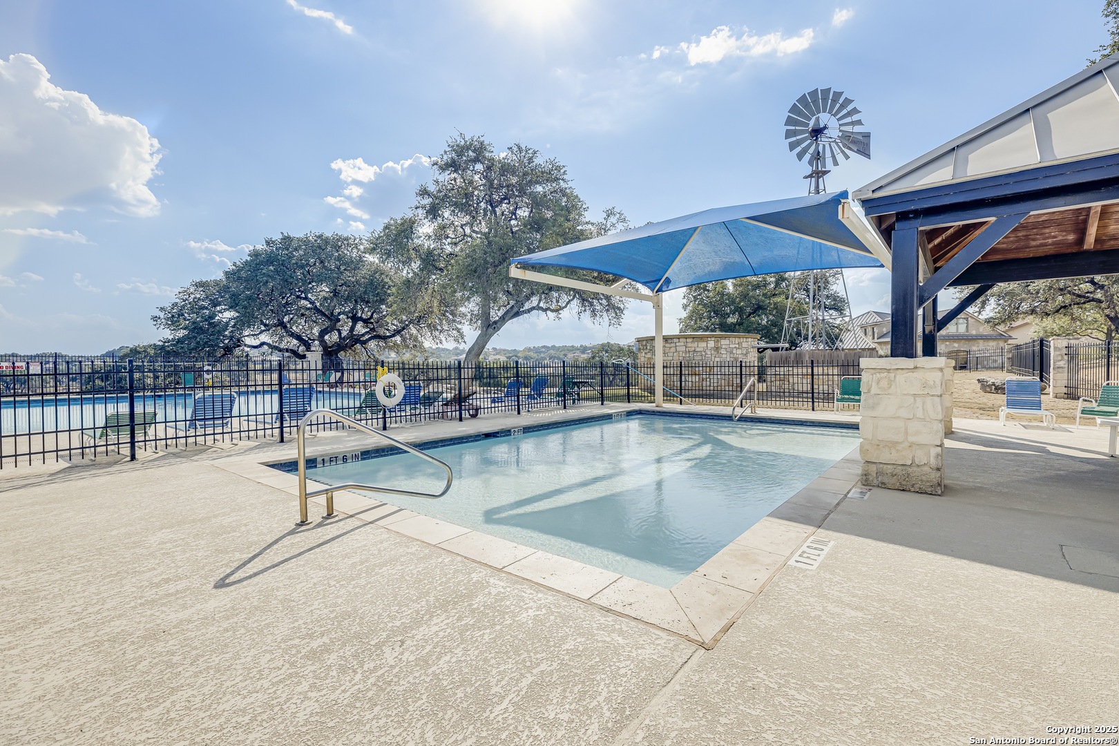 534 Rock Trail Place Spring Branch, TX 78070 - Photo 18 of 27 a view of a swimming pool with a table and chairs under an umbrella