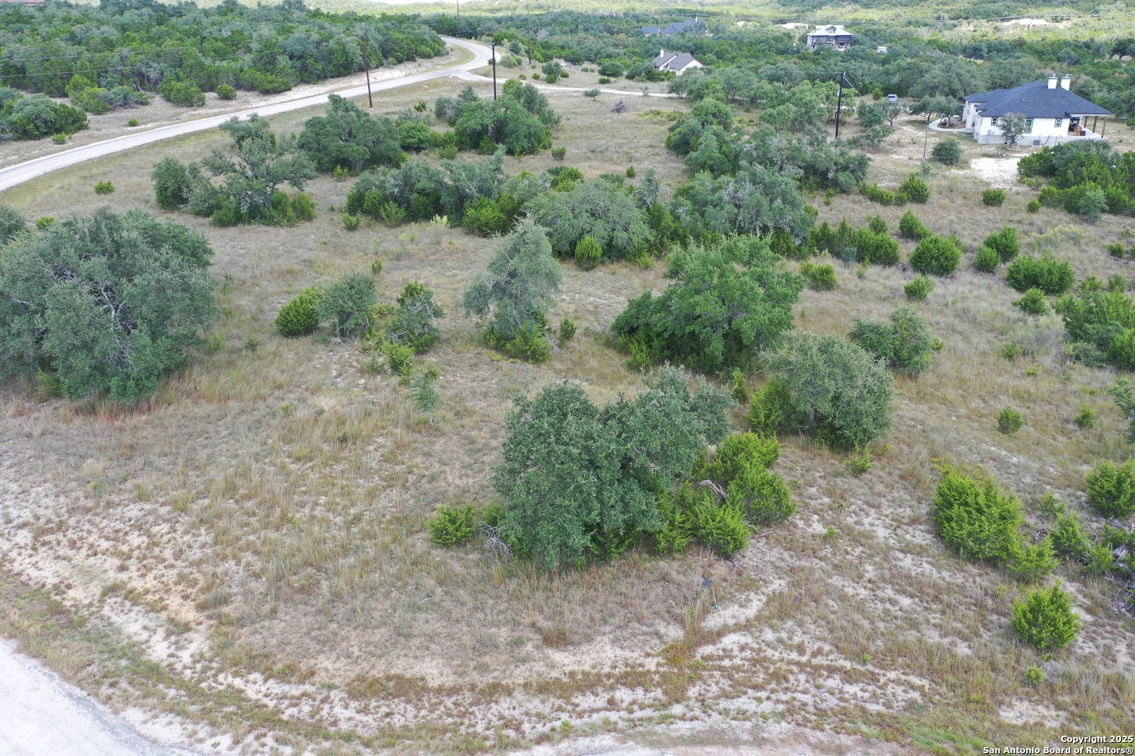 534 Rock Trail Place Spring Branch, TX 78070 - Photo 5 of 27 a view of a dry yard with trees
