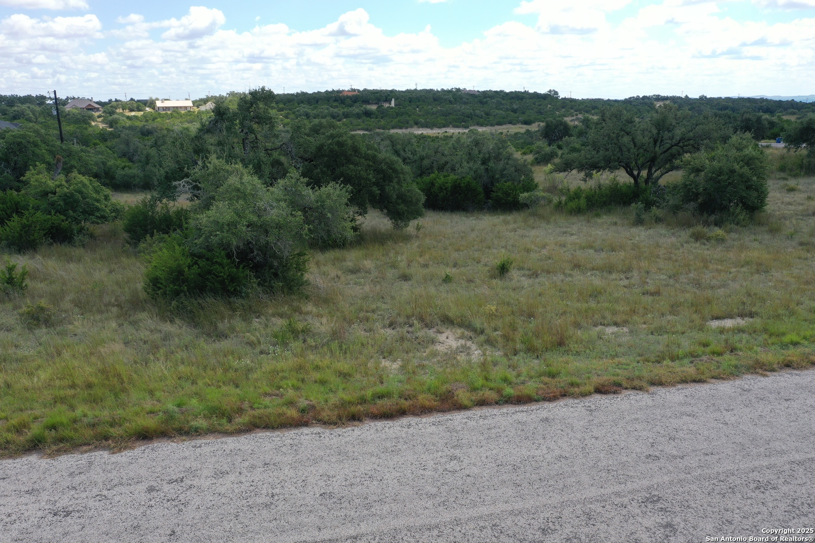 534 Rock Trail Place Spring Branch, TX 78070 - Photo 10 of 27 a view of a dry yard with green space