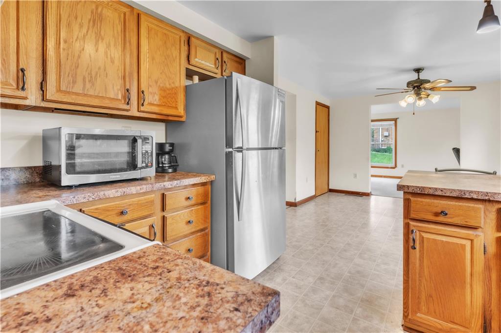 1636 Brodhead Road Coraopolis, PA 15108 - Photo 11 of 30 This kitchen comes complete with a sleek stainless-steel fridge and microwave, blending style with functionality.