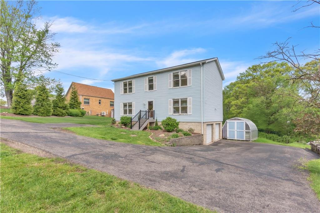 1636 Brodhead Road Coraopolis, PA 15108 - Photo 2 of 30 Curb appeal meets convenience! A new front porch adds charm, while a spacious driveway offers ample parking and easy access.