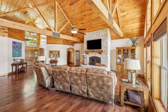 a living room with furniture a fireplace and a flat screen tv