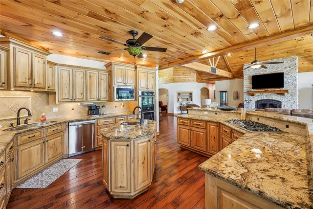 a kitchen with stainless steel appliances granite countertop a stove sink and cabinets