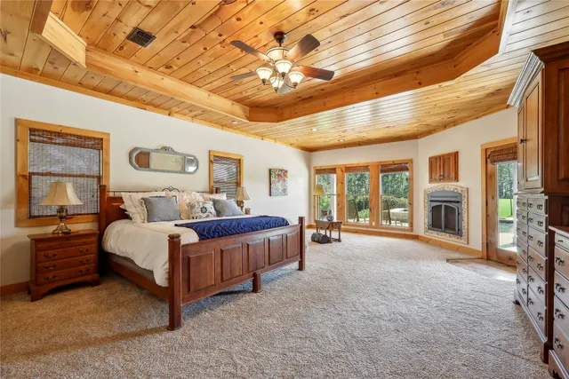a spacious bedroom with a large bed and a chandelier