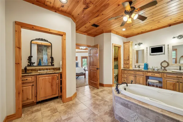 a large spacious bathroom with a double vanity sink a mirror and a bathtub