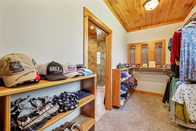 a bedroom with furniture and a large window