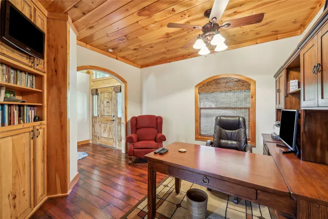 a view of a workspace with furniture window and wooden floor