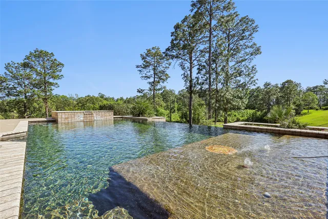 a view of a patio with table and chairs under an umbrella