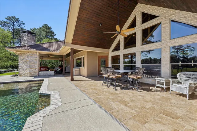a patio with yard glass top table and chairs