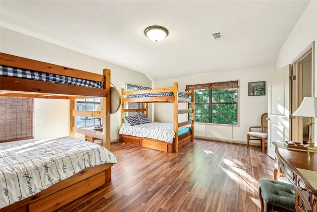 a bedroom with two beds and a couch