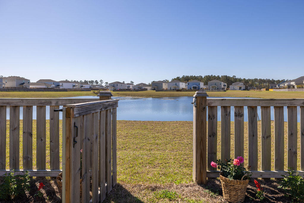 538 Spanish Wells Road Summerville, SC 29486 - Photo 3 of 41 fenced in yard leading to pond