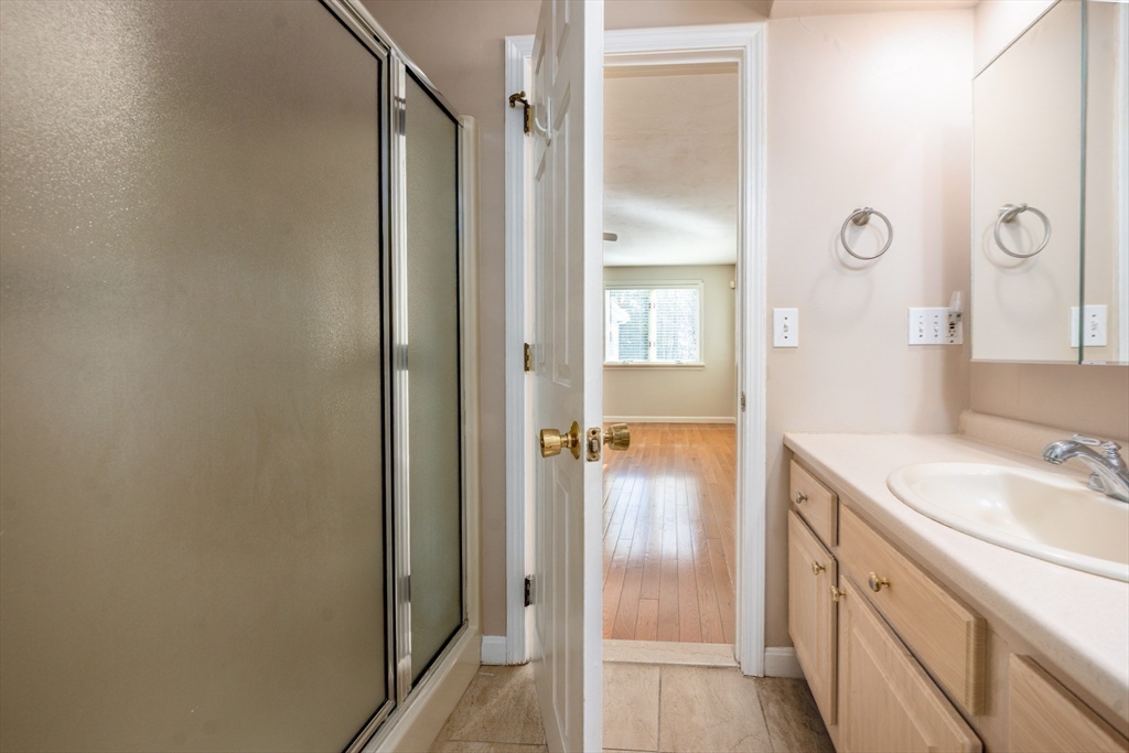 50 Pine Hill Boulevard, Unit 46 Mashpee, MA 02649 - Photo 11 of 19 a bathroom with a sink and a mirror