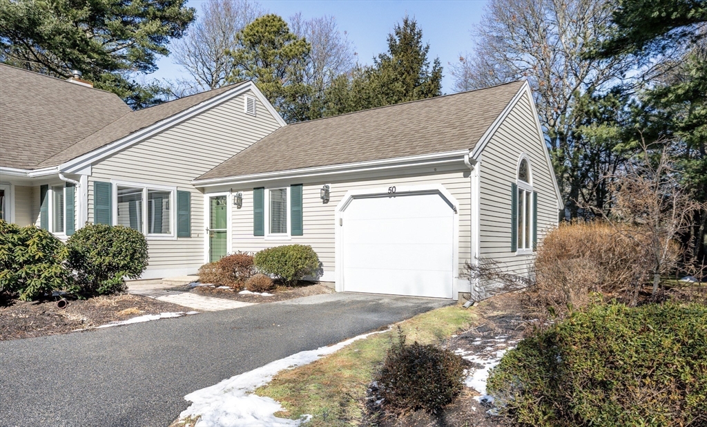 50 Pine Hill Boulevard, Unit 46 Mashpee, MA 02649 - Photo 18 of 19 a house with trees in front of it