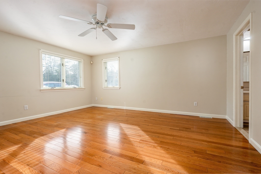 50 Pine Hill Boulevard, Unit 46 Mashpee, MA 02649 - Photo 8 of 19 a view of an empty room with wooden floor and a window