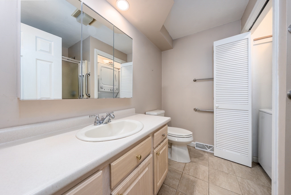 50 Pine Hill Boulevard, Unit 46 Mashpee, MA 02649 - Photo 10 of 19 a bathroom with a sink a toilet and a mirror