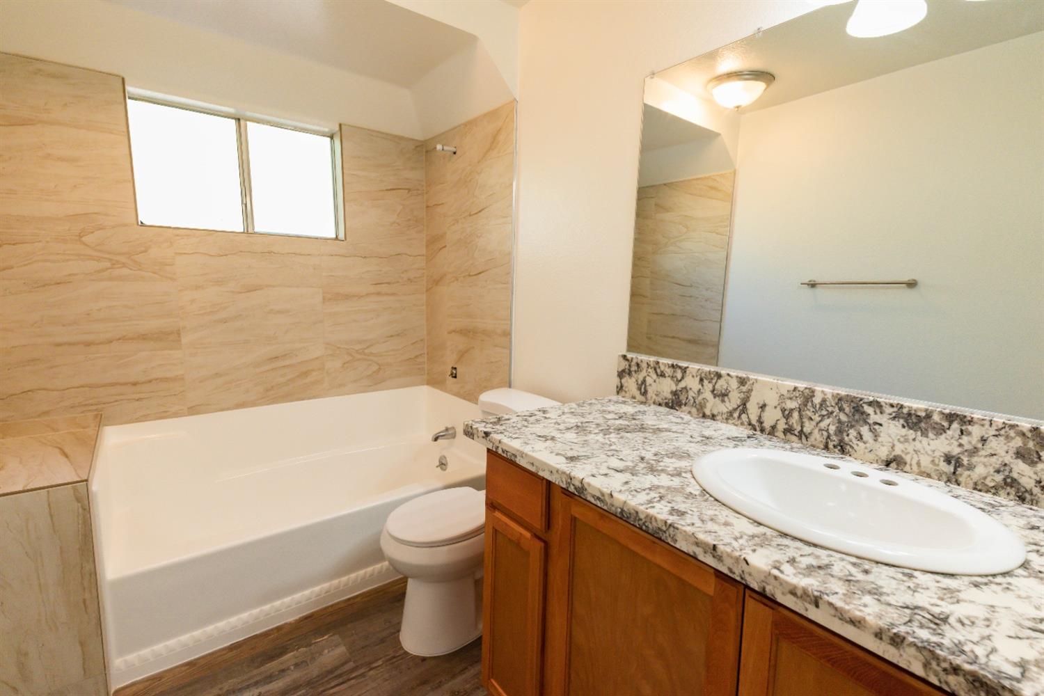 31838 Comanche Road Coarsegold, CA 93614 - Photo 11 of 19 a bathroom with a granite countertop sink toilet and bathtub