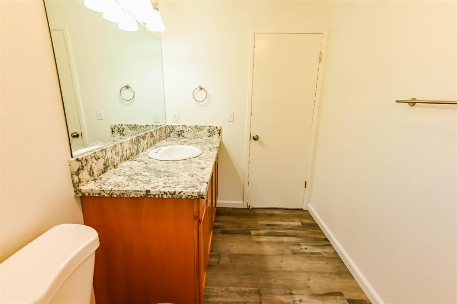 31838 Comanche Road Coarsegold, CA 93614 - Photo 12 of 19 a bathroom with a granite countertop sink and a mirror