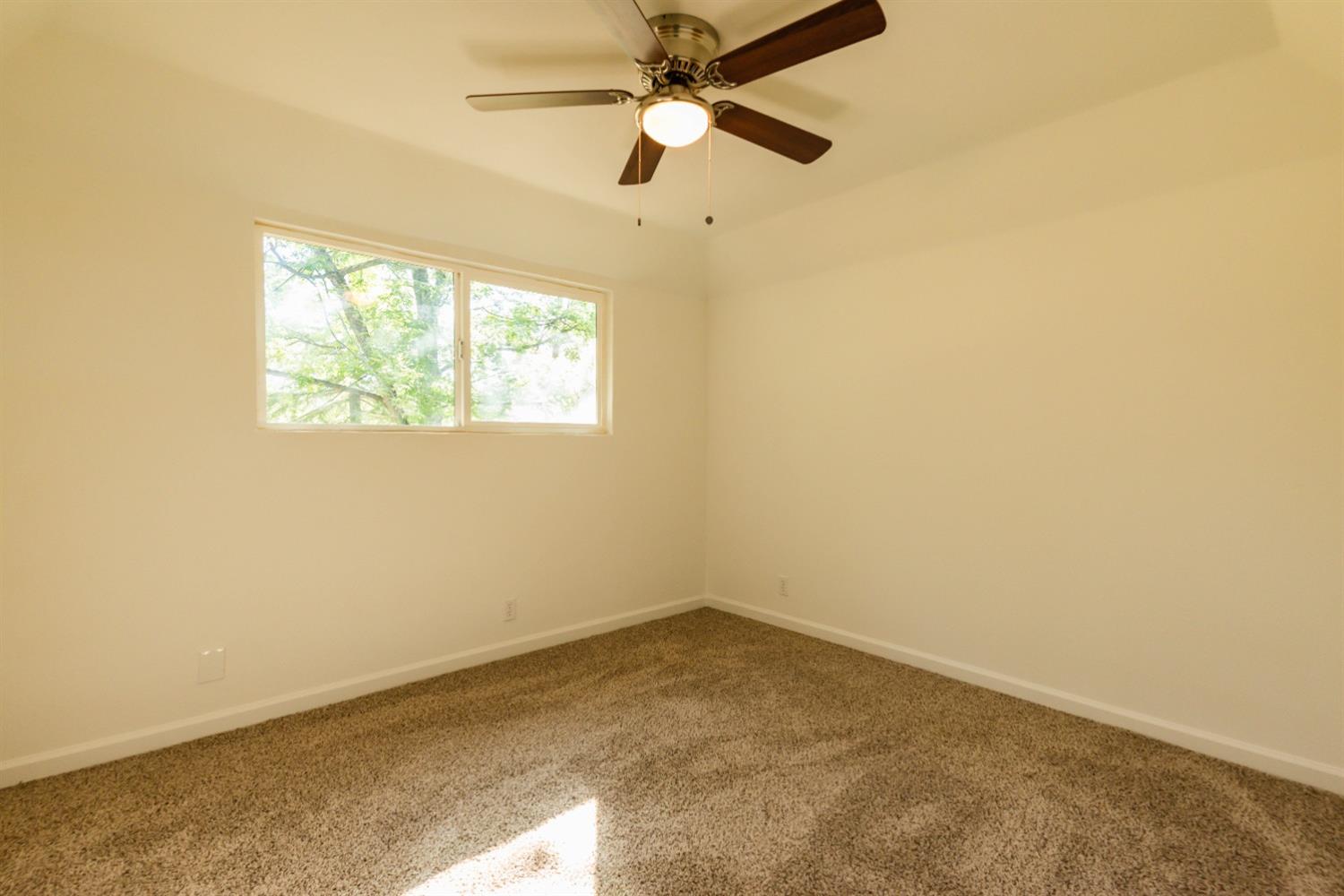 31838 Comanche Road Coarsegold, CA 93614 - Photo 13 of 19 an empty room with a window and a fan