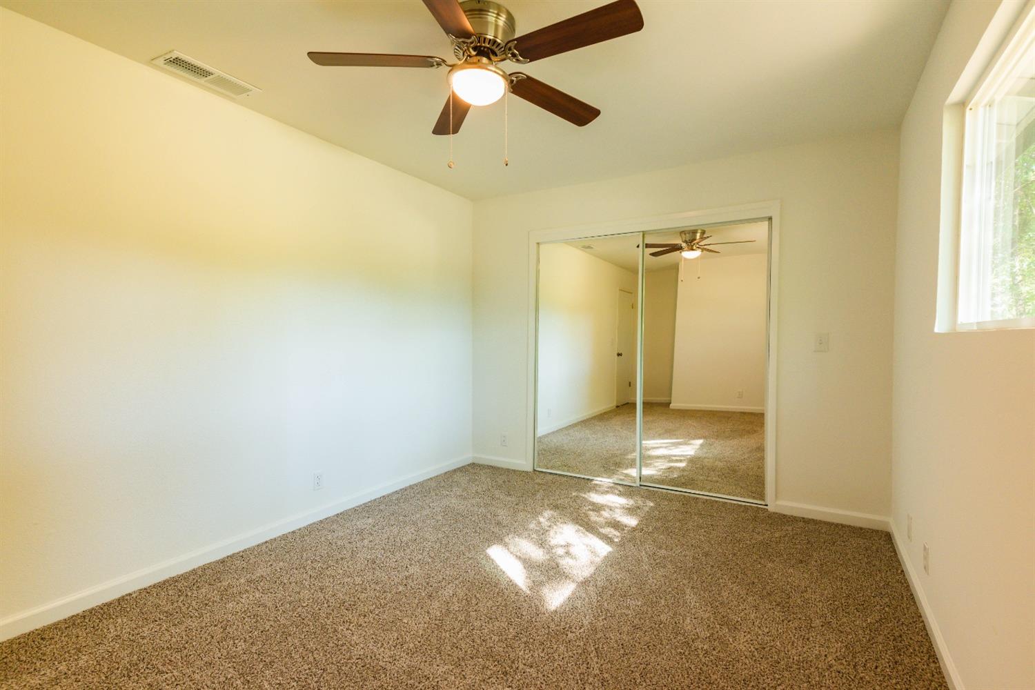 31838 Comanche Road Coarsegold, CA 93614 - Photo 15 of 19 a view of a livingroom with a chandelier fan and a window