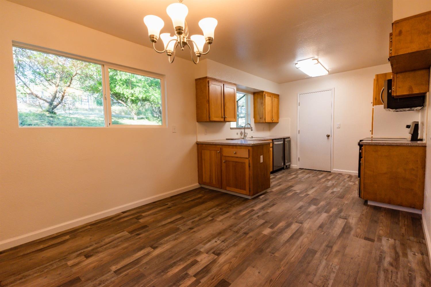 31838 Comanche Road Coarsegold, CA 93614 - Photo 8 of 19 a view of a room with wooden floor and cabinet