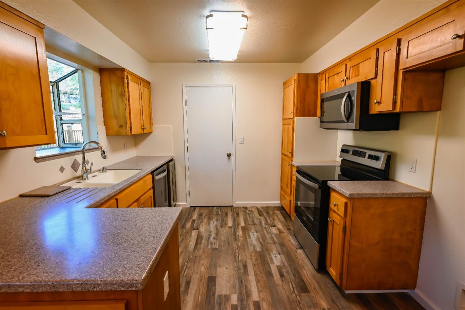 31838 Comanche Road Coarsegold, CA 93614 - Photo 9 of 19 a view of a kitchen with wooden floor and cabinets
