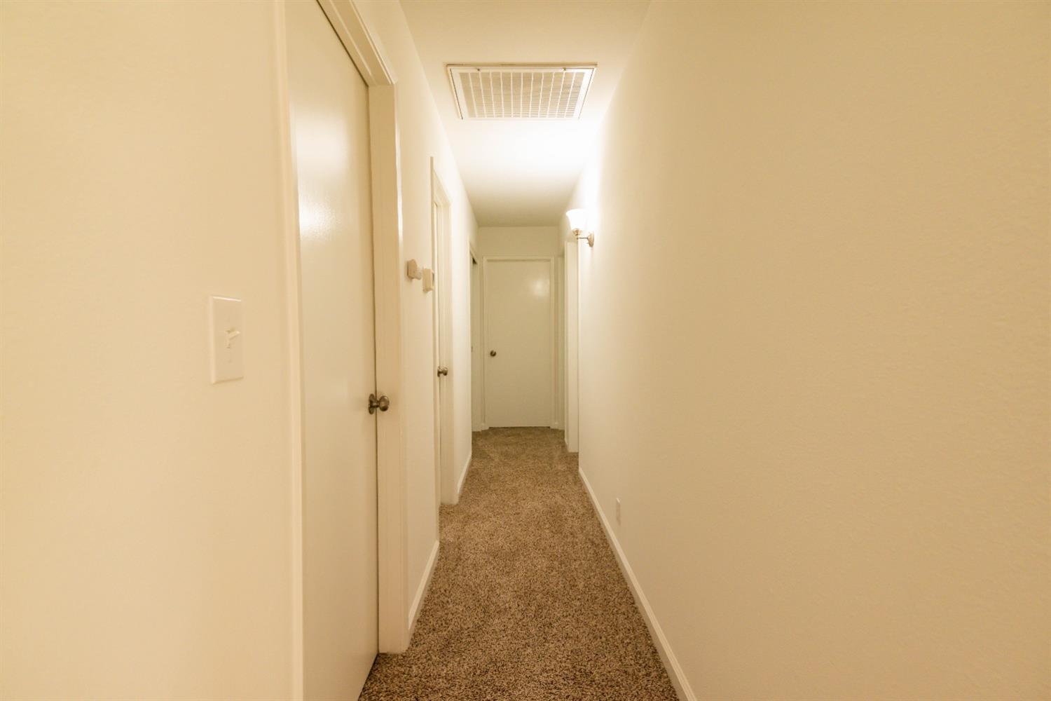 31838 Comanche Road Coarsegold, CA 93614 - Photo 10 of 19 a view of a hallway with wooden floor